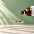 Herbion Ivy Leaf Cough Syrup poured into a spoon